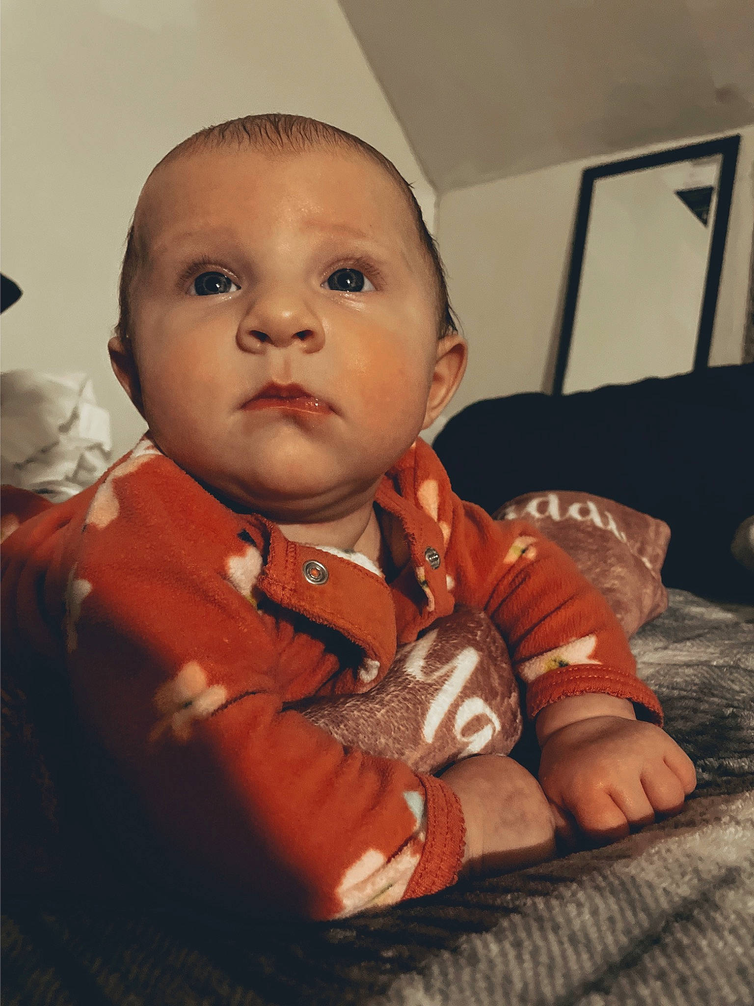 Maddison is registered to the contest to win money with this photo: baby, baby_toddler_clothing, brown, cheek, child, comfort, ear, flooring, fun, happy, iris, lifejacket, lip, nose, person, room, sitting, skin, sleeve, thumb