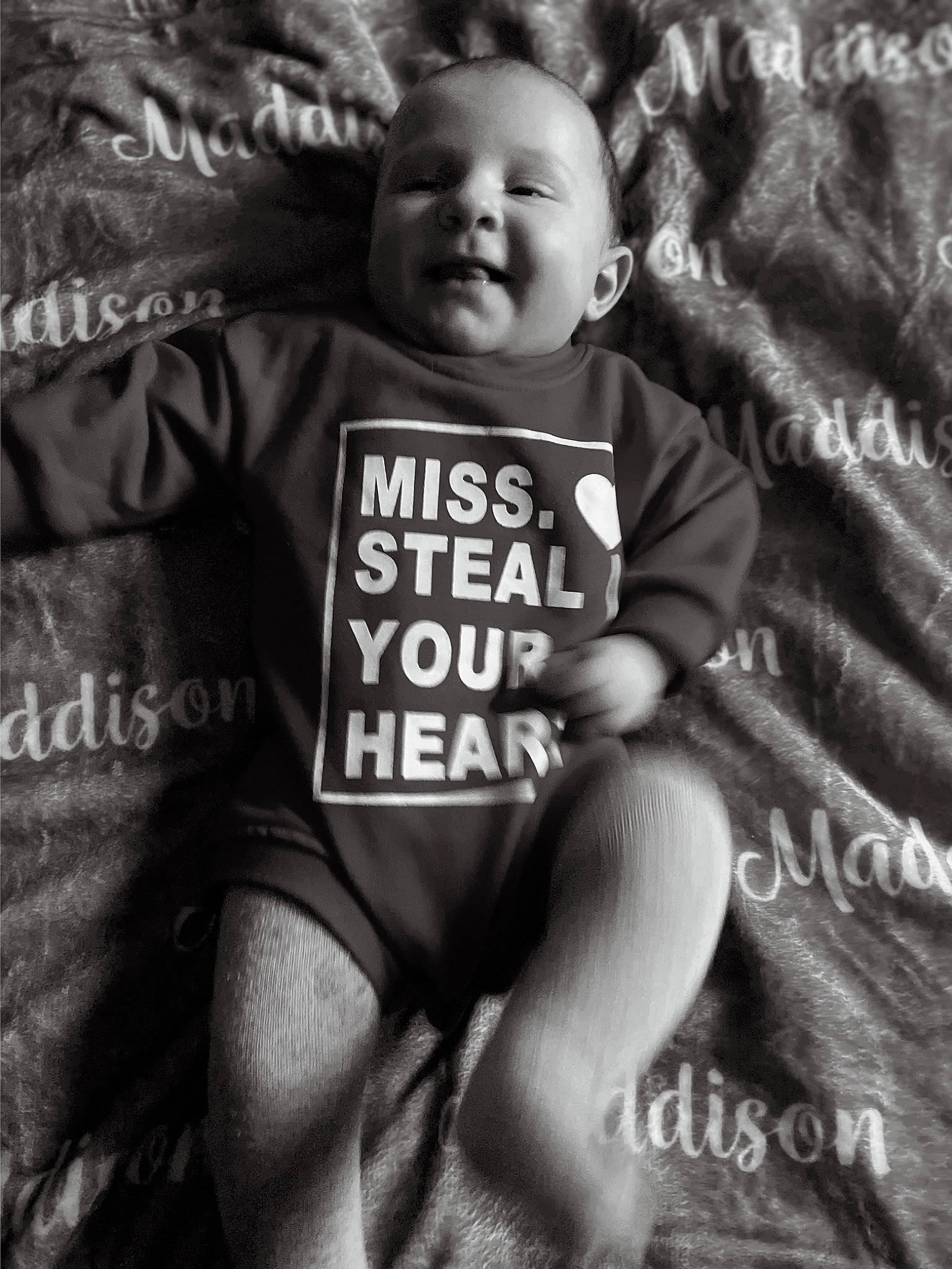 Maddison joined the competition — help win amazing prizes! baby, black, black_and_white, child, font, grey, happy, human_leg, monochrome, monochrome_photography, person, photo_caption, sleeve, smile, snapshot, stock_photography, style, t_shirt, thigh, toddler