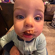 Camron joined the competition — help win amazing prizes! toddler, child, face, chocolate, messy, close_up, blue_eyes, pajamas, floor, couch, laundry_basket, indoor, curious, baby, expression, hands, person, home, furniture, smudge