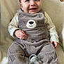 baby, smiling, corduroy_overalls, bear_design, pacifier, blanket, infant, clothing, cute, happy, sitting, soft_texture, child, indoors, portrait, toddler, warm, cozy, comfort, closeup