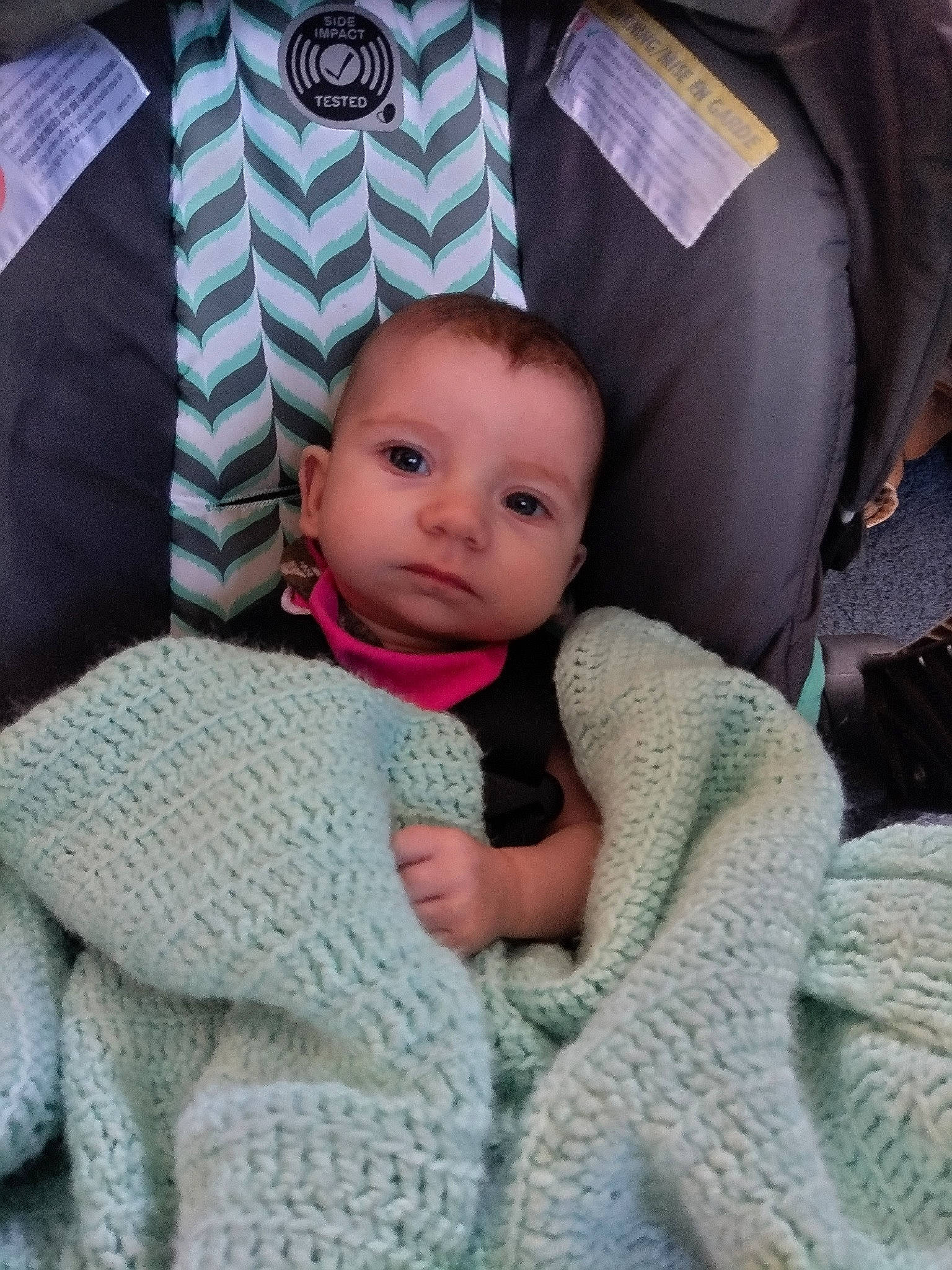 Kiara is registered to the contest to win money with this photo: baby, baby_products, baby_toddler_clothing, car_seat, child, comfort, fashion_accessory, grey, knit_cap, linens, pattern, person, product, sitting, skin, sleeve, textile, thumb, toddler, wool