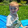 Monty joined the competition — help win amazing prizes! toddler, child, smiling, outdoor, grass, sunlight, blue_mat, casual_clothing, green_shorts, white_tshirt, happy, playing, nature, garden, daytime, portrait, face, young_child, sitting, summer