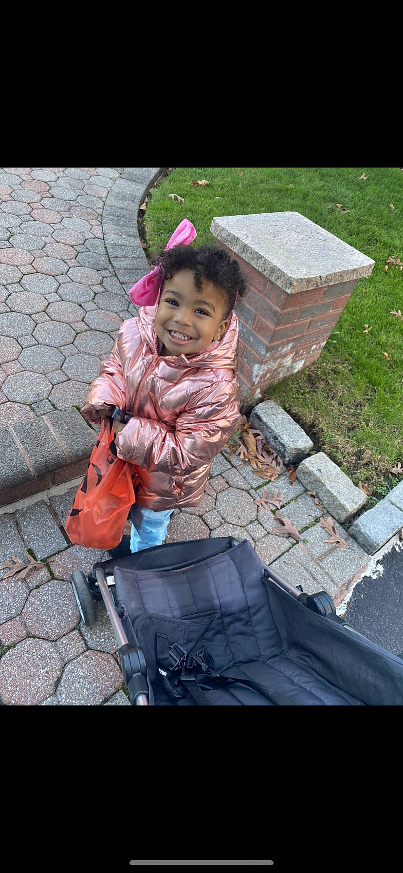 Priya is registered to the contest to win money with this photo: asphalt, baby, baby_carriage, baby_products, bag, child, fun, grass, joy, leisure, luggage_and_bags, people_in_nature, person, pink, play, recreation, road_surface, sidewalk, sitting, smile