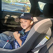 Leo joined the competition — help win amazing prizes! child, boy, car_seat, car_interior, baseball_cap, smile, seatbelt, window, sunlight, shadow, clothing, happy, seat, vehicle, person, casual, transportation, safety, daylight, portrait
