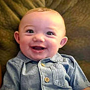 Tyrin joined the competition — help win amazing prizes! baby, smiling, child, blue_shirt, buttoned_shirt, face, happy, infant, portrait, seated, indoors, cozy, cute, young, person, childhood, skin, head, eyes, mouth