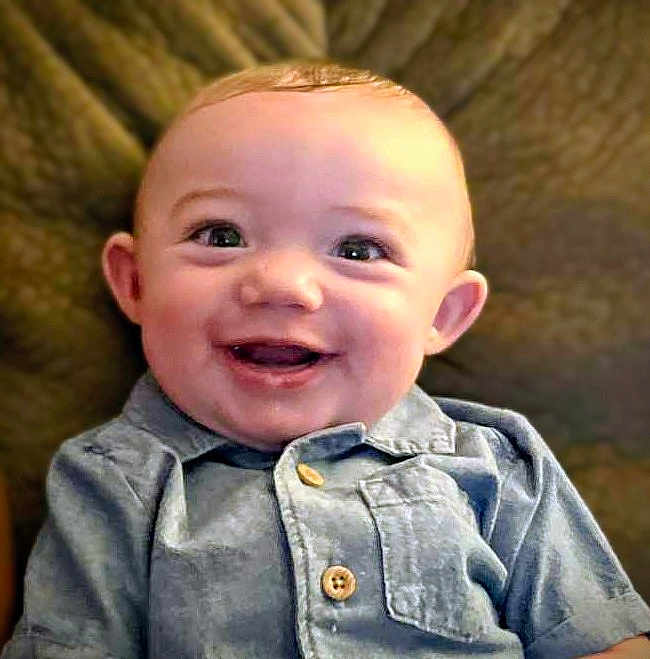 Tyrin joined the competition — help win amazing prizes! baby, smiling, child, blue_shirt, buttoned_shirt, face, happy, infant, portrait, seated, indoors, cozy, cute, young, person, childhood, skin, head, eyes, mouth