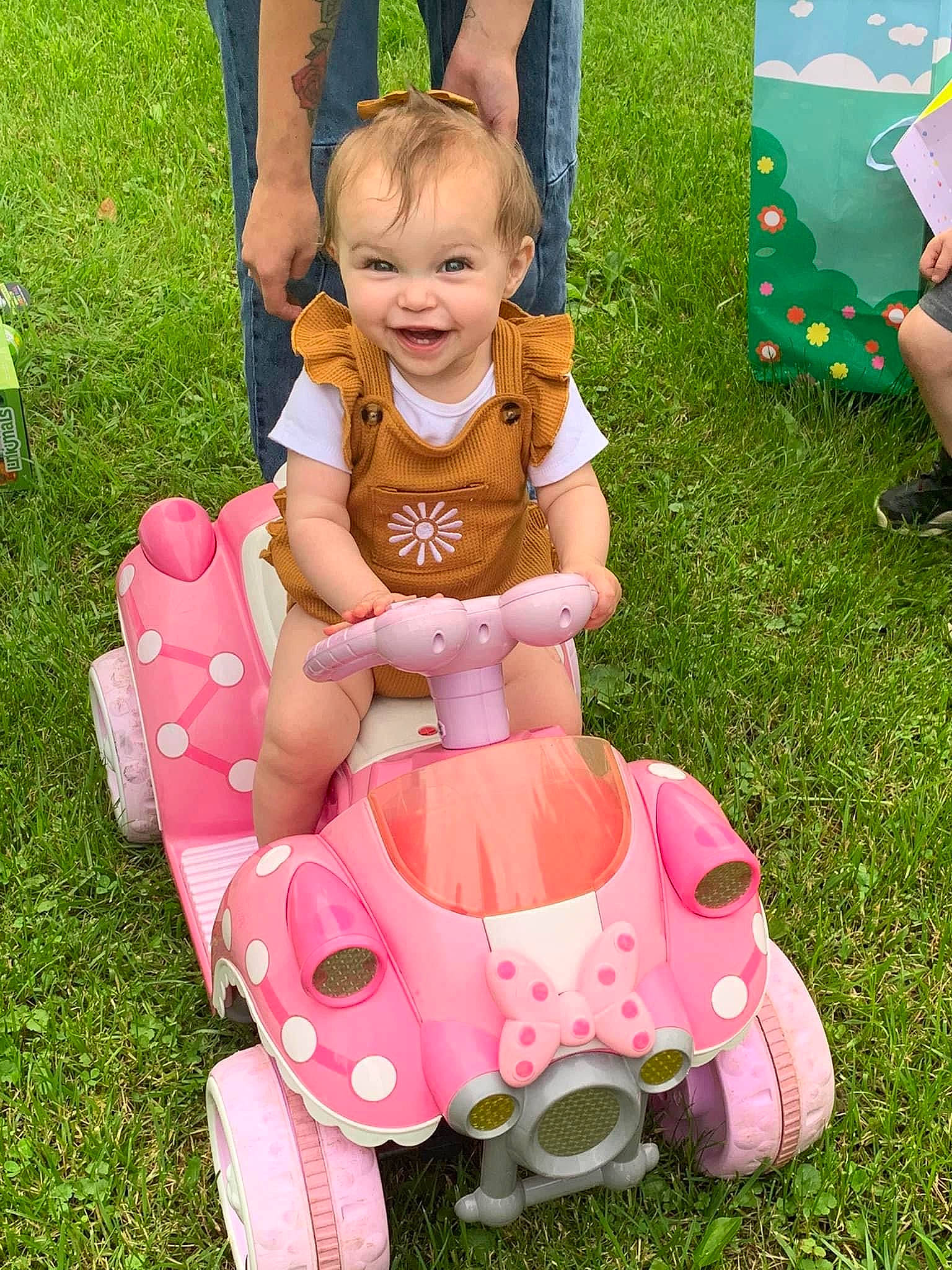 Renesmee joined the competition — help win amazing prizes! baby, baby_toddler_clothing, dress, grass, green, happy, lap, leisure, person, pink, recreation, riding_toy, shoe, shorts, skin, smile, tire, toddler, toy, vehicle