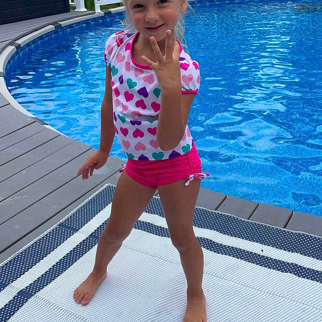 Mckenna is registered to the contest to win money with this photo: backyard, clothing, face, head, leisureactivities, nature, outdoors, person, photography, pool, portrait, shorts, sport, summer, swimming, swimmingpool, swimwear, water, watersports, yard