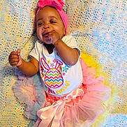 Ava is registered to the contest to win money with this photo: baby, infant, child, tutu, headband, pink, easter, crocheted_blanket, pastel_colors, smiling, chewing, hand, clothing, cute, celebration, lying_down, playful, portrait, colorful, happy