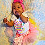 baby, infant, child, tutu, headband, pink, easter, crocheted_blanket, pastel_colors, smiling, chewing, hand, clothing, cute, celebration, lying_down, playful, portrait, colorful, happy