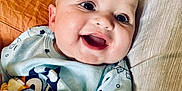 Greyson joined the competition — help win amazing prizes! baby, bed, blanket, blue, child, clothing, comfort, cozy, cute, expression, face, happy, indoors, infant, lying_down, pillow, portrait, skin, smiling, young