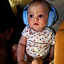 Greyson is registered to the contest to win money with this photo: baby, casual, child, comfort, couch, curious, cute, expression, face, hand, headphones, indoor, infant, leg, onesie, person, seated, skin, soft_lighting, star_pattern
