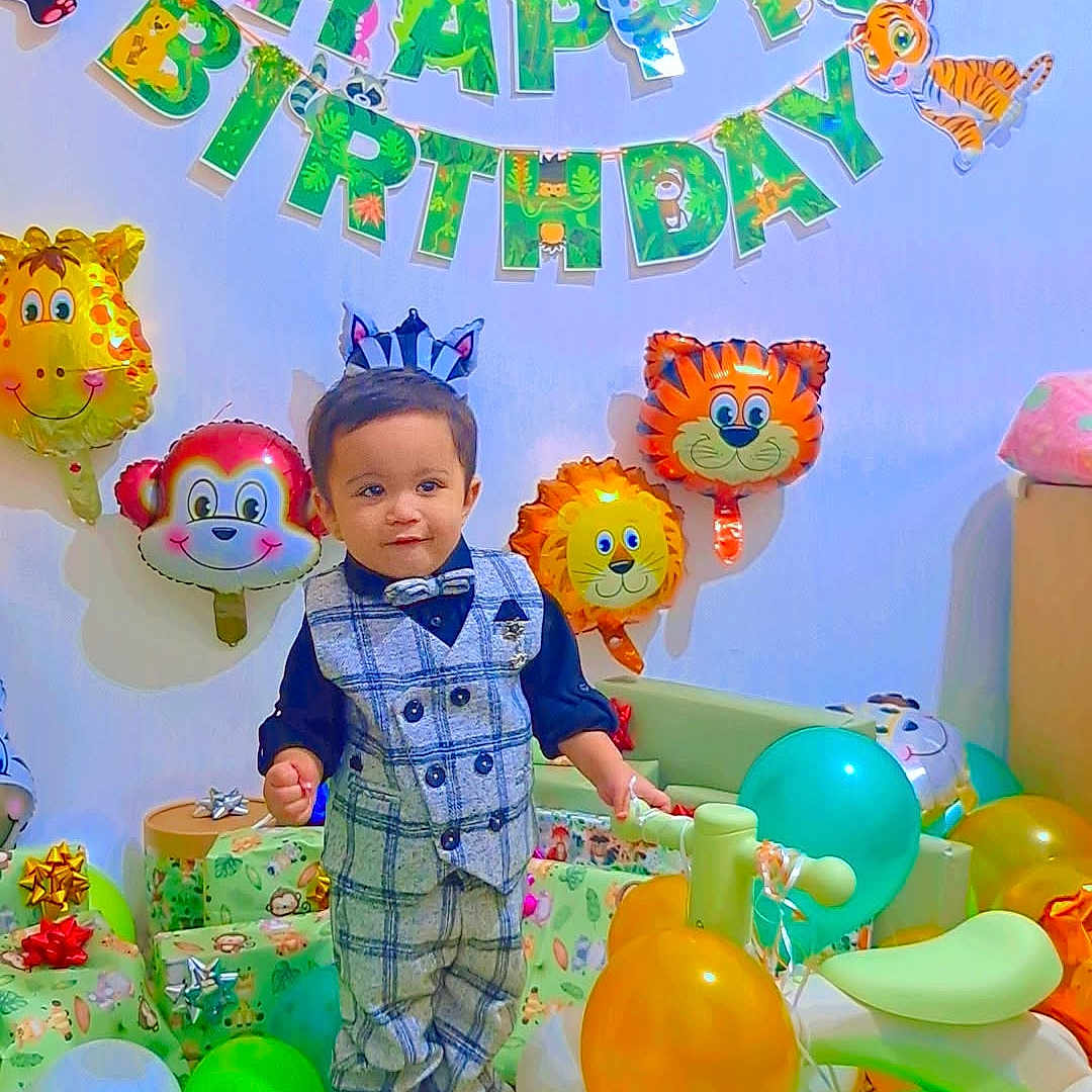 Ali Mujtaba is registered to the contest to win money with this photo: animal_balloons, balloons, birthday_banner, birthday_party, bow_tie, celebration, child, elephant, floor, gift_wrapping, giraffe, lion, monkey, panda, plaid_suit, present, tiger, toddler, toy_vehicle, zebra