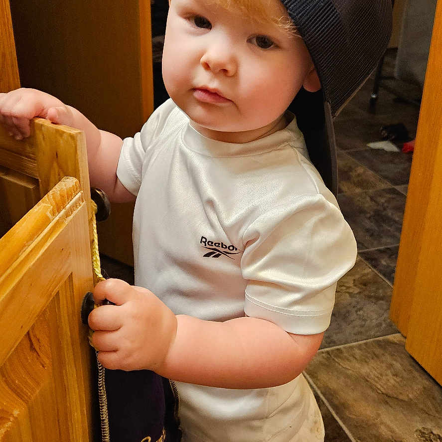 Teryn joined the competition — help win amazing prizes! baby, baseballcap, bodypart, cabinet, cap, clothing, face, finger, furniture, hand, hardwood, hat, head, indoors, interiordesign, person, photography, plywood, portrait, wood