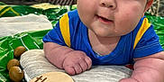 Luka joined the competition — help win amazing prizes! baby, infant, three_months, blue_shirt, yellow_stripes, pillow, mini_football, green_mat, indoors, curious_expression, drool, face, hands, child, cute, playtime, closeup, portrait, newborn, smiling