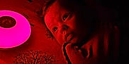 Lilith joined the competition — help win amazing prizes! baby, infant, bed, blanket, night_light, red_light, face, eyes, indoor, sleeping_area, soft_lighting, curious, portrait, child, cozy, quiet, darkness, bedding, tree_pattern, wrapped