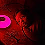 baby, infant, bed, blanket, night_light, red_light, face, eyes, indoor, sleeping_area, soft_lighting, curious, portrait, child, cozy, quiet, darkness, bedding, tree_pattern, wrapped