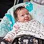 baby, infant, blanket, cozy, cute, tongue_out, smile, face, clothing, pattern, soft, indoors, child, wrapped, head, hair, playful, happy, person, resting