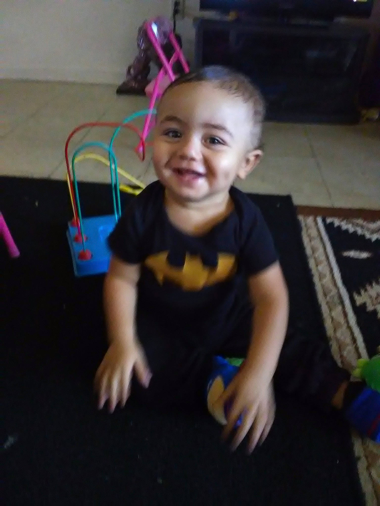 Joseph is registered to the contest to win money with this photo: arm, baby, cheek, child, ear, electronic_device, face, facial_expression, floor, fun, happy, head, human_body, iris, joy, person, photography, play, sitting, skin