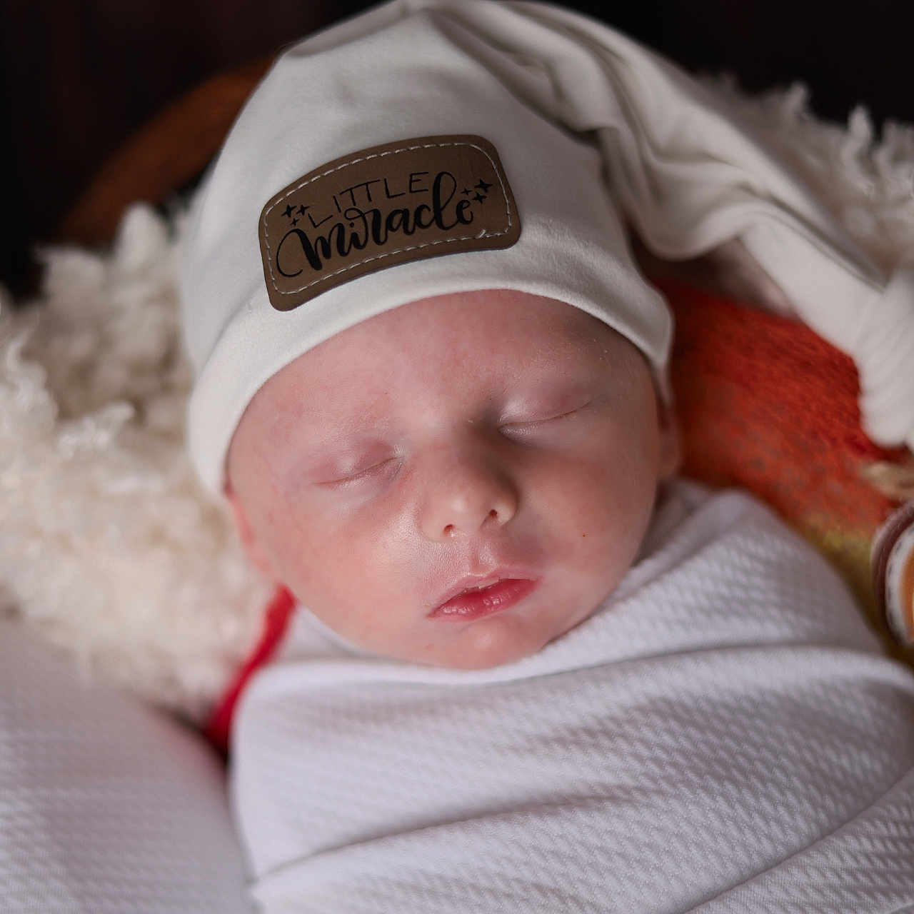 Titus is registered to the contest to win money with this photo: baby, beanie, blanket, bodypart, bonnet, cap, clothing, face, finger, hand, hat, head, knitwear, newborn, person, photography, portrait, sleeping, sweater