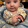 baby, baby_seat, blue_eyes, child, closeup, curious, cute, expression, face, floral_pattern, hands, indoor, infant, onesie, padded_seat, person, portrait, sitting, skin, young