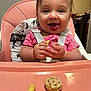 baby, cereal, cheeks, hair, hands, happy, highchair, infant, kitchen, pink, polka_dot, portrait, puffed_snack, shirt, sitting, smile, snack, strap, tongue_out, tray