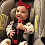 baby, baby_clothes, car_seat, child, closeup, clothing, cute, face, happy, harness, headband, indoors, infant, person, red_bow, safety, seat, seat_belt, small_child, smiling