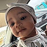 baby, child, face, head_wrap, car_interior, window, seatbelt, clothing, infant, portrait, closeup, person, cute, young_child, car_dashboard, seat, expression, indoors, light, soft