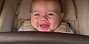 Rome joined the competition — help win amazing prizes! baby, smiling, infant, car_seat, safety_harness, blue_clothing, blanket, cute, child, indoor, happy, closeup, person, seatbelt, soft_texture, young_child, portrait, baby_hand, human_face, cozy