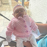 Ivy joined the competition — help win amazing prizes! newborn, baby, pink_sweater, knitted_hat, sleeping, indoor, person, baby_mittens, white_pants, holding, window, glass_door, rainy, patio, furniture, wood_floor, child, cute, peaceful, soft_lighting