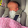 Ivy is registered to the contest to win money with this photo: newborn, baby, car_seat, blanket, knitted, pink, white_sweater, sleeping, infant, child, safety_harness, airbag_warning, soft, cozy, indoors, portrait, cute, peaceful, head, face