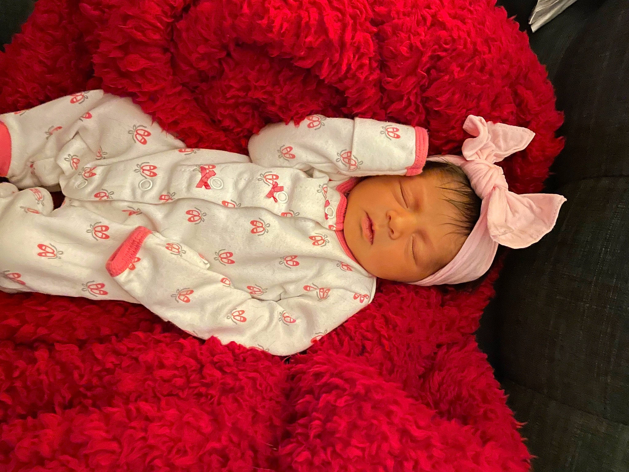 Amani is registered to the contest to win money with this photo: baby, baby_sleeping, baby_toddler_clothing, bedding, bedtime, carmine, child, comfort, fur, hat, linens, magenta, pattern, person, pink, red, room, skin, sleeve, textile