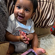 Deaaron joined the competition — help win amazing prizes! baby, child, infant, sitting, smiling, happy, portrait, face, eyes, hands, couch, cushion, tablet, indoors, home, furniture, patterned_fabric, short_hair, casual_clothing, playtime