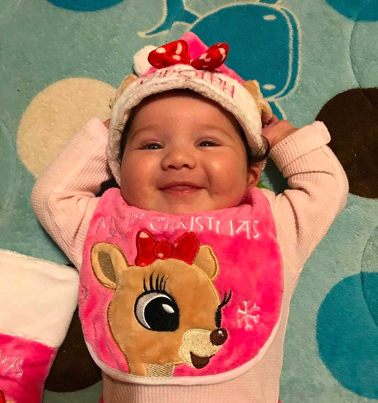 Cynthia is registered to the contest to win money with this photo: baby, baby_products, baby_toddler_clothing, bib, cheek, child, eye, face, fashion_accessory, happy, headgear, headwear, joy, linens, outerwear, person, pink, skin, sleeve, smile
