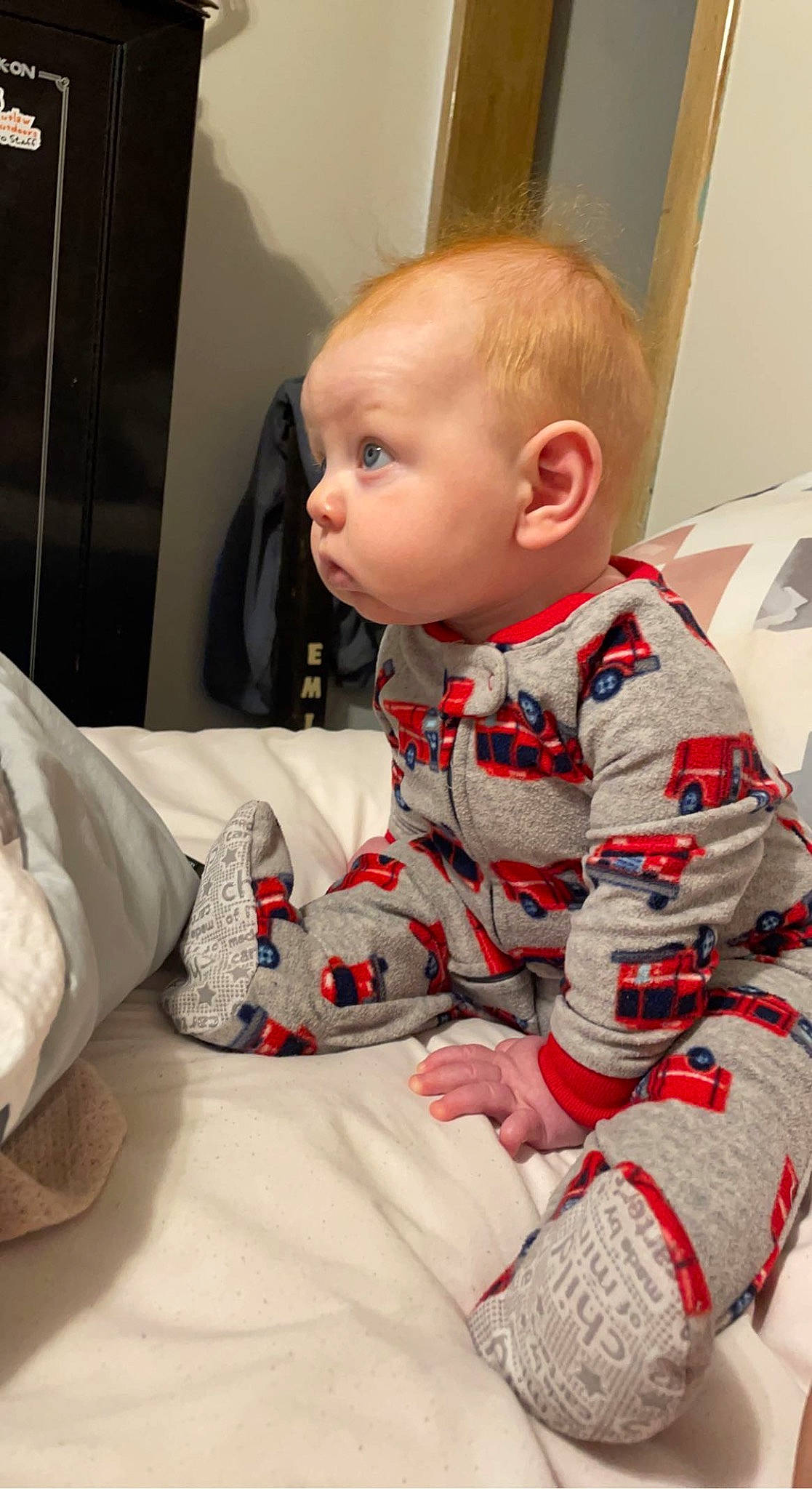 Colt is registered to the contest to win money with this photo: baby, baby_toddler_clothing, bedding, carmine, child, collar, comfort, lap, linens, nightwear, pattern, person, plaid, room, sitting, sleeve, t_shirt, toddler