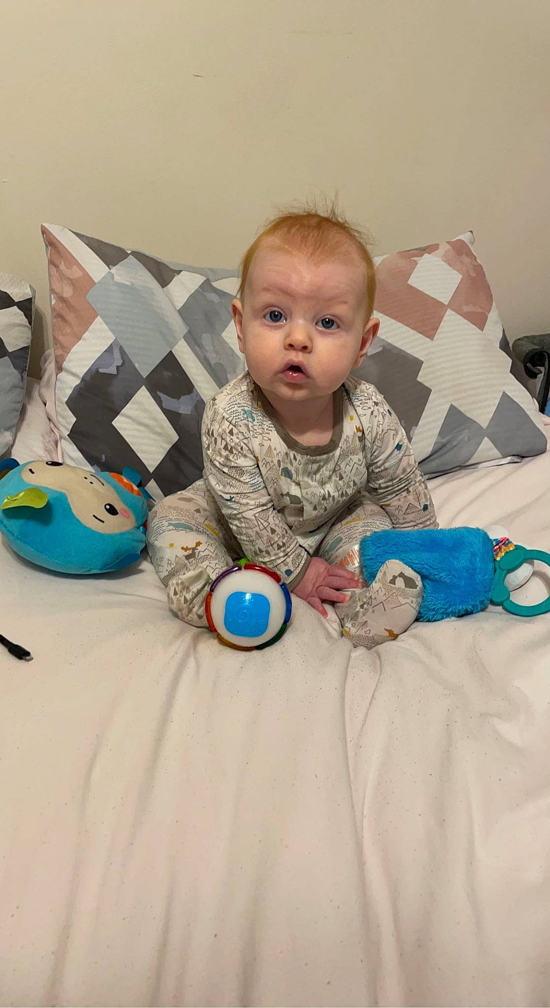 Colt is registered to the contest to win money with this photo: baby, baby_products, baby_toddler_clothing, baby_toys, child, comfort, flooring, fun, happy, head, linens, person, play, product, room, sitting, skin, surprise, textile, throw_pillow