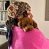 Elley participe au concours pour gagner de l'argent avec cette photo : bookshelf, brown_dog, comfort, cozy, cuddling, cute, dog, earrings, face, fluffy, headscarf, home, hugging, indoor, person, pink_sweater, portrait, record_collection, relaxed, warm