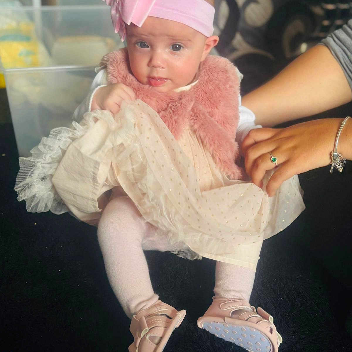 Sylvie joined the competition — help win amazing prizes! accessory, baby, baby_shoes, bow, child, clothing, cute, dress, floor, hand, indoor, person, pink_headband, pink_vest, portrait, sitting, soft_texture, support, tights, young_child