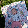 baby, infant, child, portrait, lying_down, outdoor, grass, blanket, floral, pink, headband, bow, clothing, onesie, pants, socks, milestone, four_months, face, photography