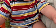 Richtofen is registered to the contest to win money with this photo: baby, child, smiling, striped_clothing, onesie, sitting, bed, happy, cute, indoor, face, cheeks, arms, legs, person, infant, skin, head, eyes, expression