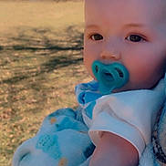 Richtofen is registered to the contest to win money with this photo: baby, pacifier, blanket, outdoor, nature, child, portrait, soft_texture, blue, grass, daylight, face, arm, clothing, trees, pavilion, sky, sunlight, cute, infant