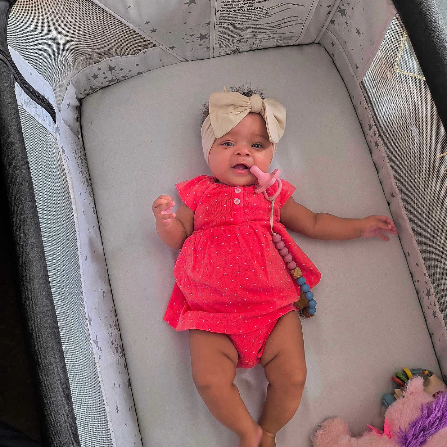Kaitlynn is registered to the contest to win money with this photo: baby, bed, bodypart, bonnet, cap, clothing, couch, cradle, crib, dress, face, finger, furniture, hand, hat, head, indoors, infantbed, nursery, person