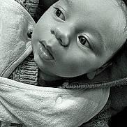 Rayan participe au concours pour gagner de l'argent avec cette photo : baby, black_and_white, child, closeup, cozy, cute, expression, face, indoors, infant, jacket, knitwear, looking_away, peaceful, portrait, skin, small_hand, soft_texture, warm_clothing, young