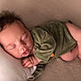 baby, blanket, closeup, cozy, cute, face, foot, green_clothing, hand, indoors, infant, newborn, peaceful, pillow, portrait, resting, skin, sleeping, soft_texture, toddler