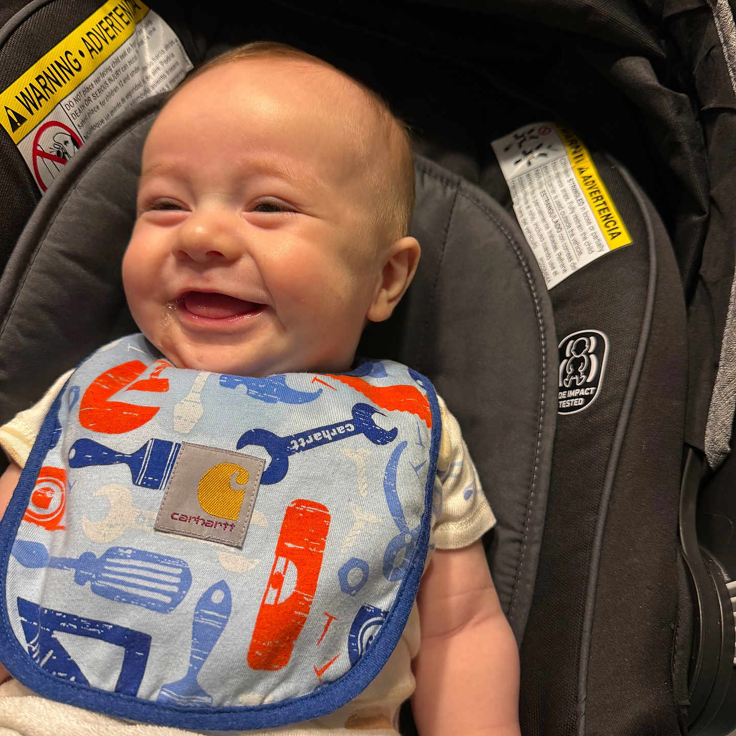 Manuelito is registered to the contest to win money with this photo: baby, baby_bib, bib, car_seat, child, closeup, clothing, cute, expression, happy, indoor, infancy, infant, joyful, person, portrait, seat, sitting, smiling, young_child