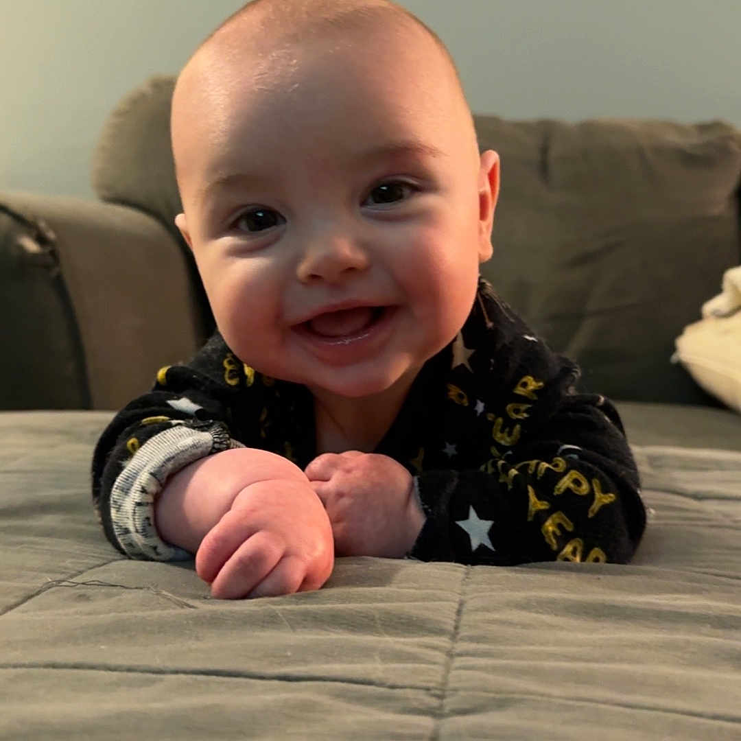 Finn is registered to the contest to win money with this photo: architecture, baby, babylaughing, bodypart, building, clothing, couch, crawling, cushion, face, finger, fist, furniture, hand, happy, head, homedecor, indoors, laughing, livingroom
