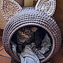 cat, tabby_cat, cozy, knitted_cave, cat_cave, blanket, pet, animal, indoor, feline, ears, curious, cute, home, floor, tiled_floor, soft, resting, looking_up, domestic_cat