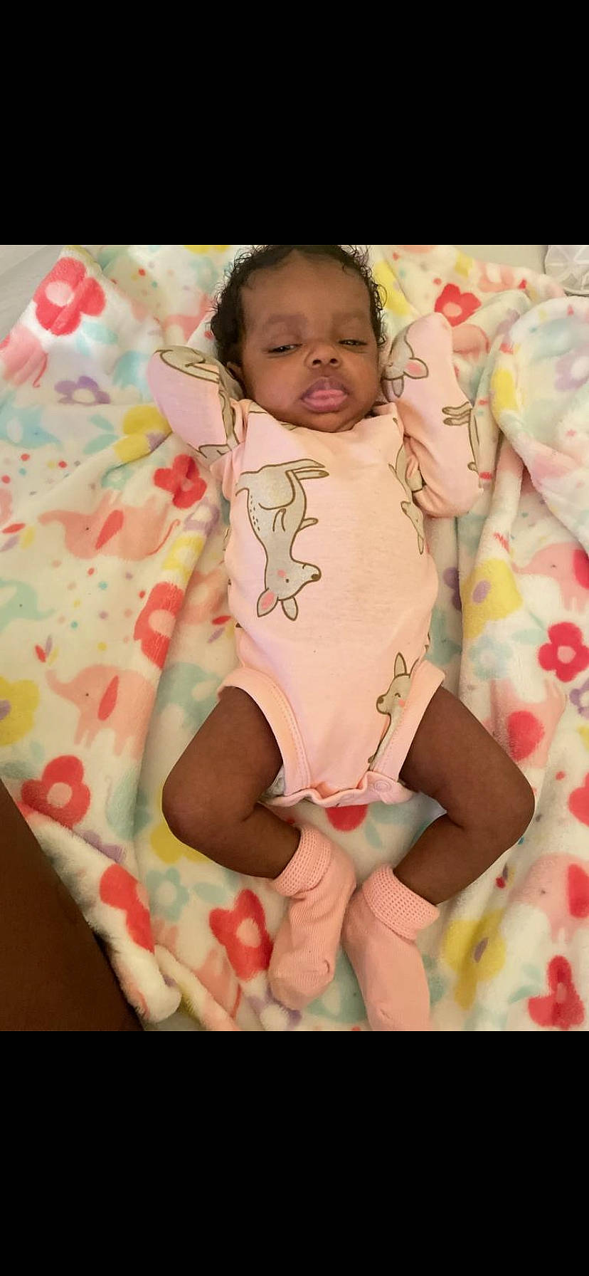 Nayve is registered to the contest to win money with this photo: baby, baby_toddler_clothing, cheek, comfort, eye, face, happy, head, leg, linens, mouth, neck, pattern, person, pink, skin, sleeve, stomach, thigh, thumb