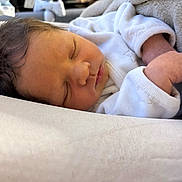 Esaya participe au concours pour gagner de l'argent avec cette photo : newborn, baby, sleeping, infant, white_clothing, blanket, soft, peaceful, closeup, face, hand, hair, indoors, resting, cute, skin, cozy, portrait, child, toddler