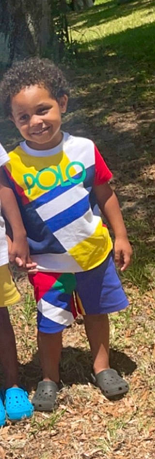 Malachi is registered to the contest to win money with this photo: adaptation, child, community, competition_event, event, fun, grass, happy, joy, leisure, person, photograph, play, recreation, shorts, sleeve, smile, soil, t_shirt, thigh